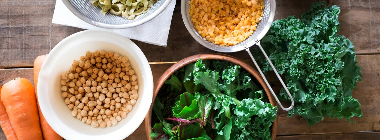 Older adult using a tablet in a bright home office with leafy greens and eggs nearby as lutein rich foods.