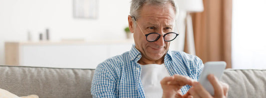 Adult child helping an older adult check vision changes with an Amsler grid at home