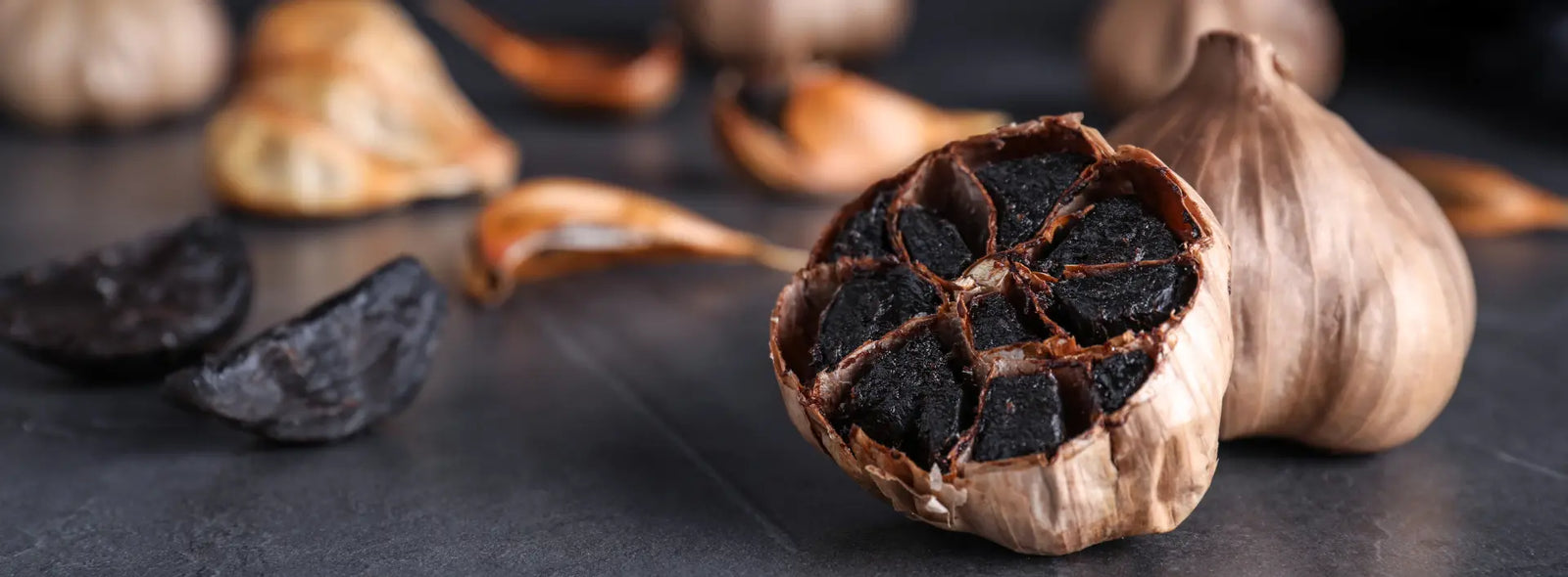 Older New Zealand adult comparing an aged black garlic supplement label with aged garlic extract research