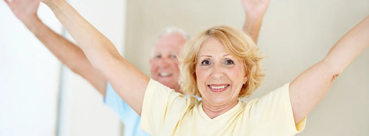 Older New Zealand adult and caregiver comparing B12, B complex, CoQ10 and a senior multivitamin