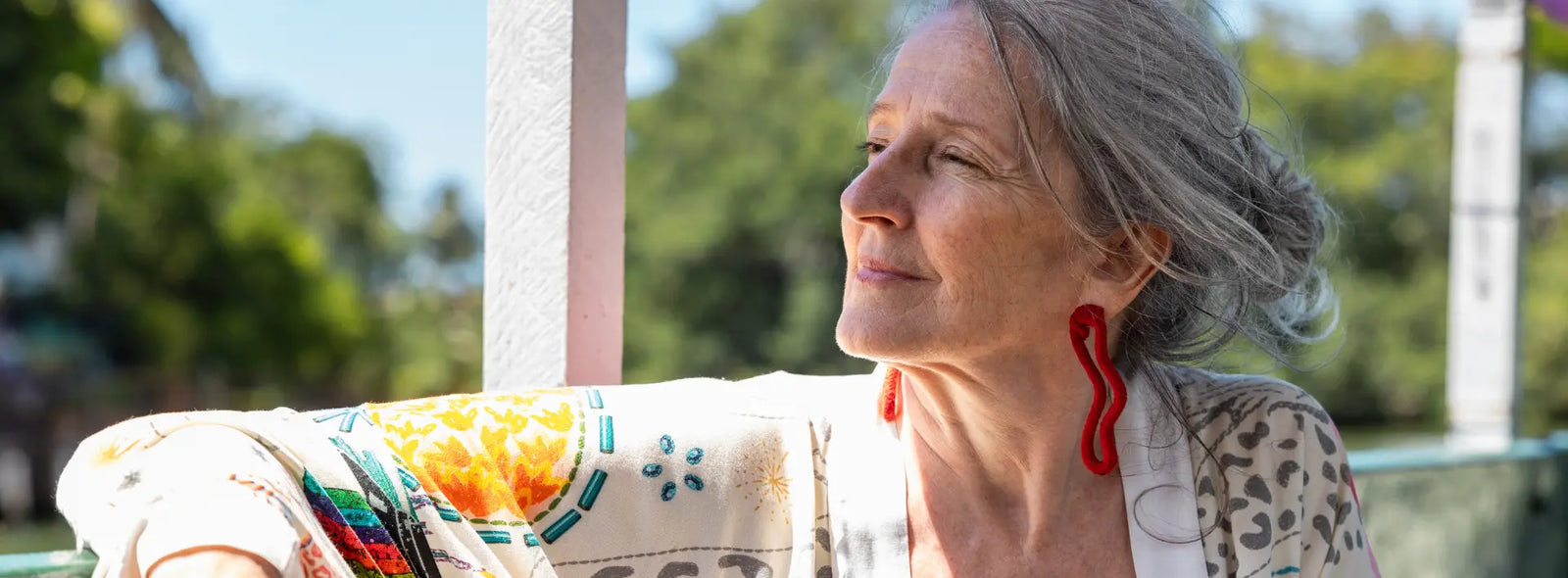 Older New Zealander and adult family member reviewing cranberry support, a medicine list and urinary symptom notes at home