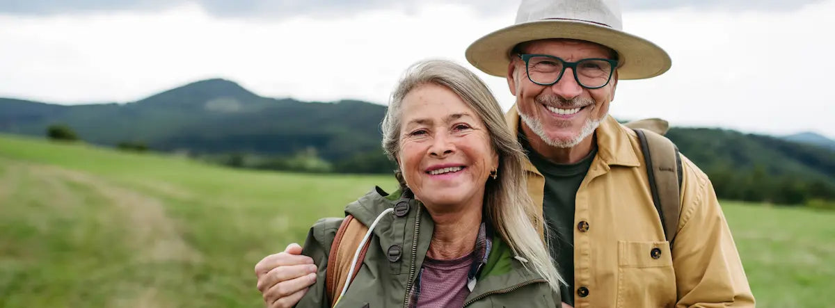 Man and woman over 60 considering a senior multivitamin together in a bright kitchen