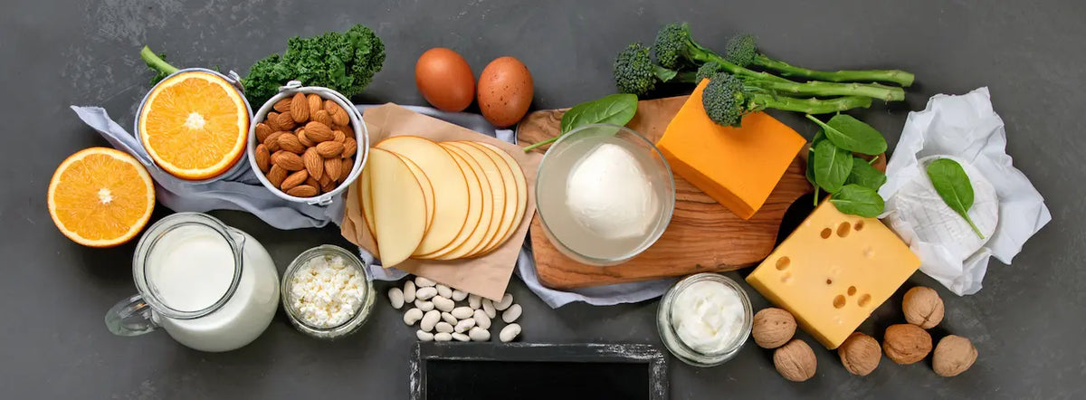 Vitamin D3 capsule beside everyday calcium-rich foods in a bright New Zealand kitchen.