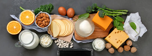 Vitamin D3 capsule beside everyday calcium-rich foods in a bright New Zealand kitchen.