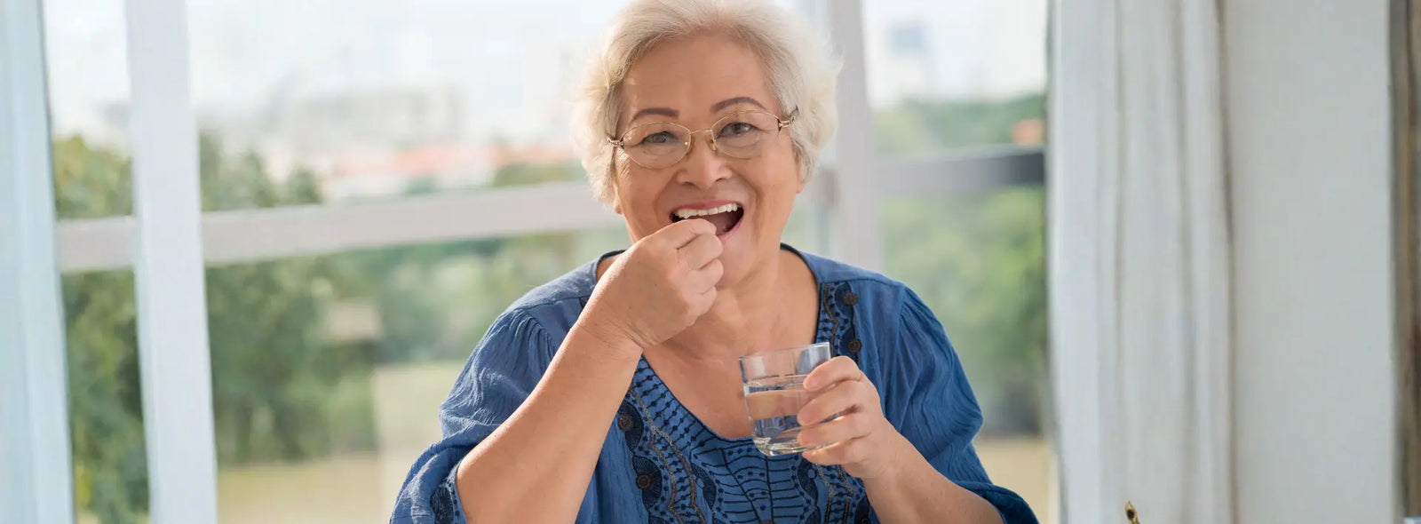 Older New Zealander comparing regular and senior multivitamin labels at a kitchen table