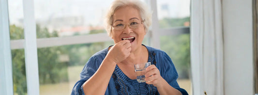 Older New Zealander comparing regular and senior multivitamin labels at a kitchen table