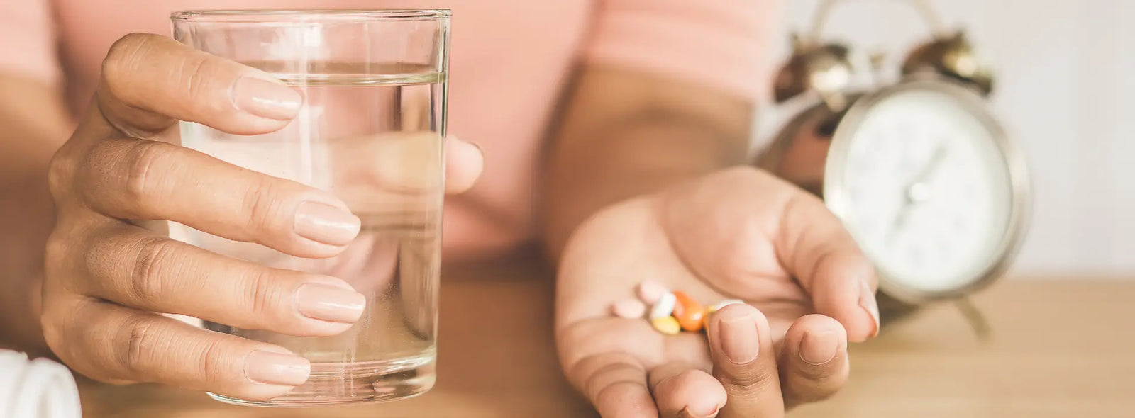 Gold Health vitamin B12 capsule beside a simple meal and glass of water in a calm New Zealand kitchen