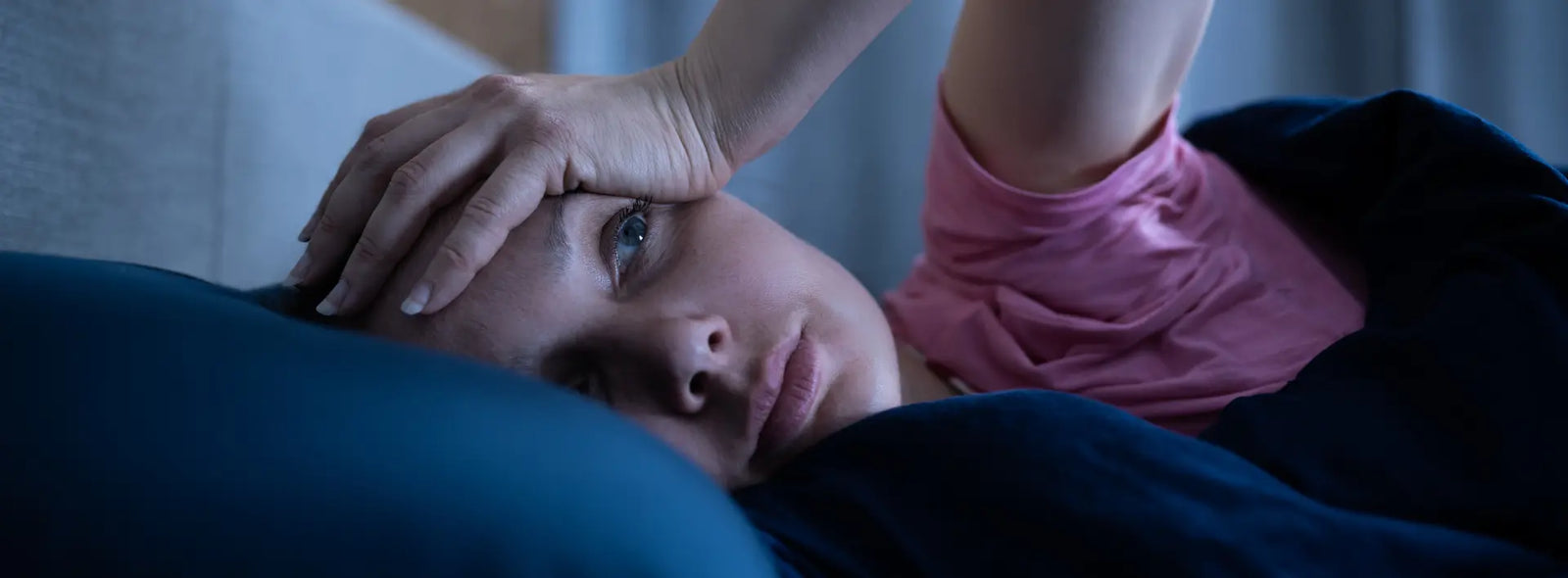 Older New Zealand adult feeling tired but wide awake while trying to fall asleep at bedtime