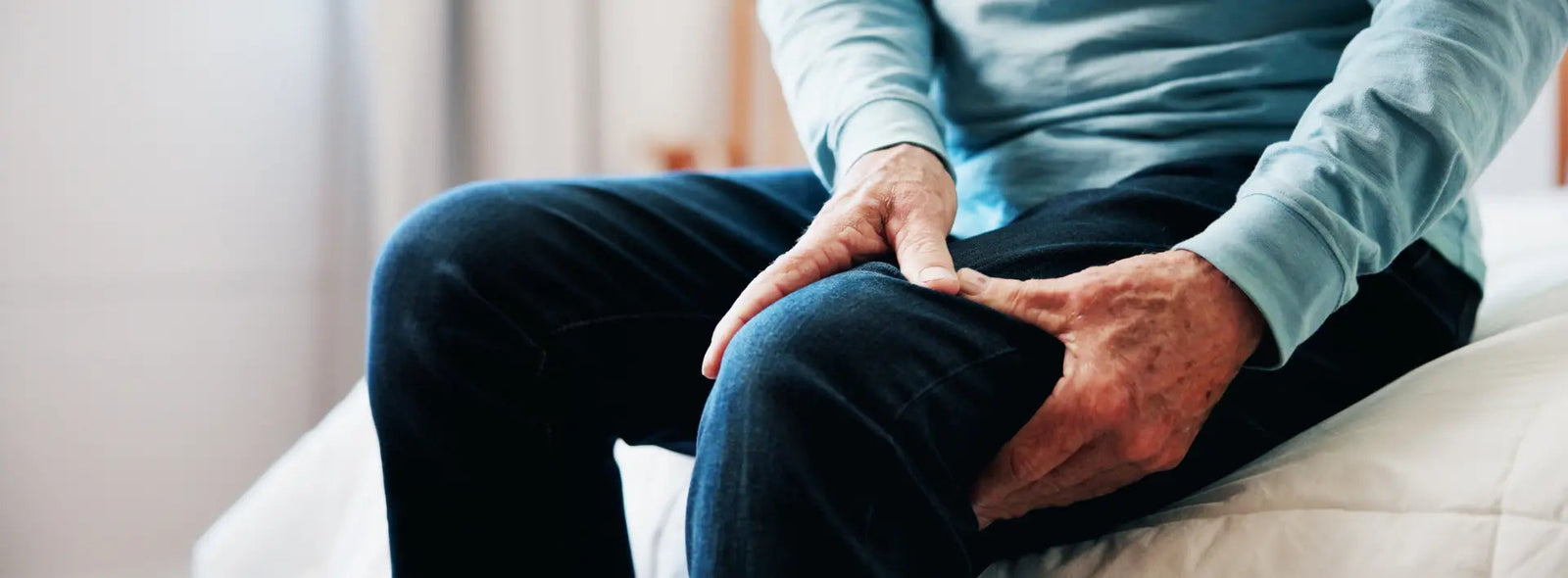 Person stretching calf to relieve a leg cramp with a glass of water nearby