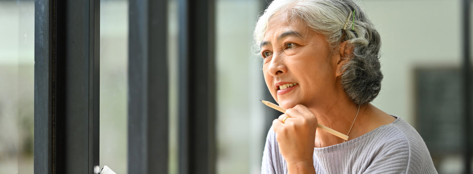 Lady thinking with a pen in her hand