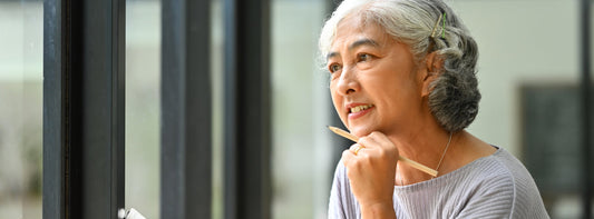 Lady thinking with a pen in her hand