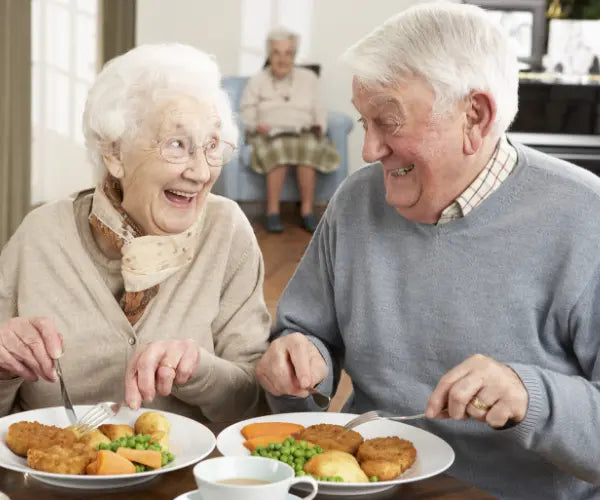 Older woman enjoying a healthy meal, representing Gold Health gut and digestion support