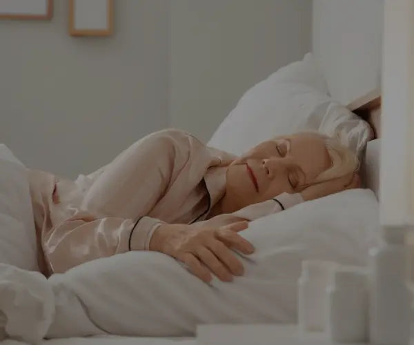 Older woman sleeping peacefully, representing Gold Health sleep support supplements